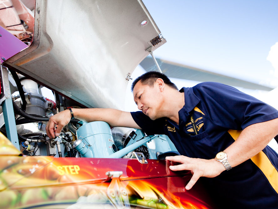 Director of Maintenance, Michael Yip, inspecting the engine bay of AS350D Squirrel Helicopter