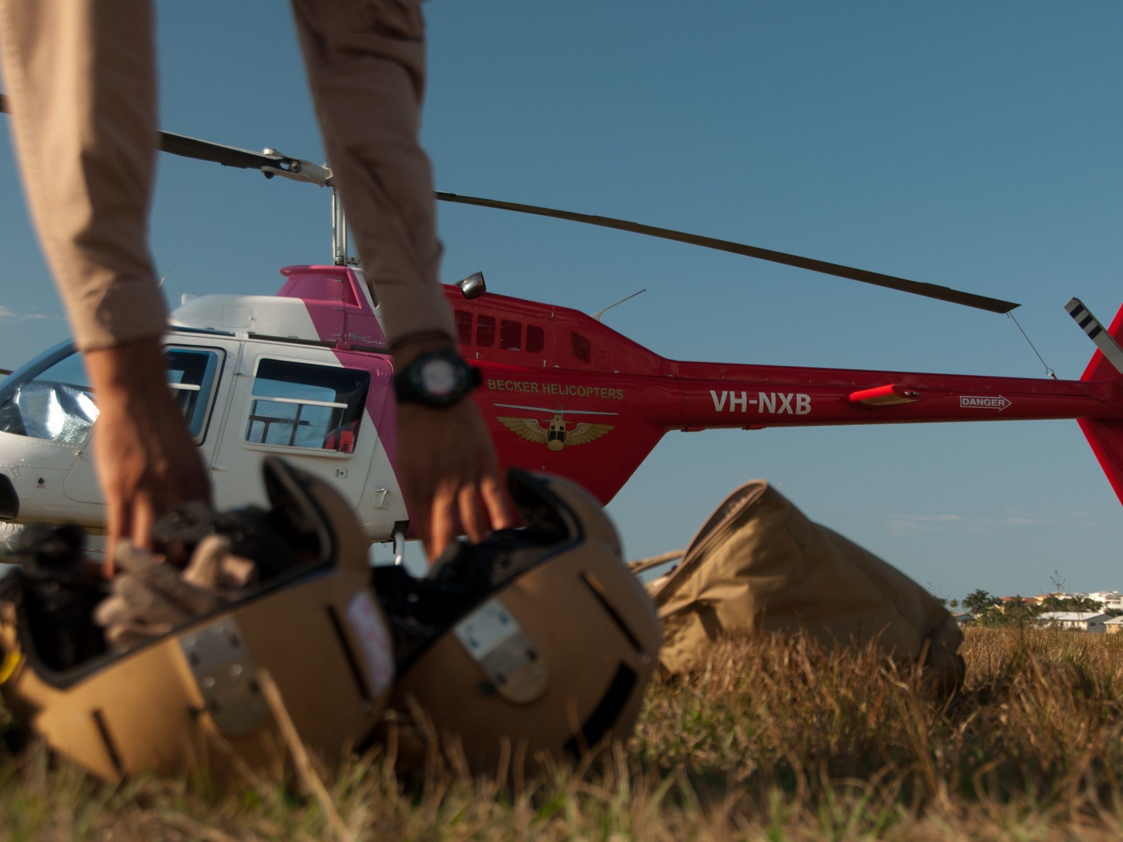Trainee pilots picking up helmets in preparation for a training flight