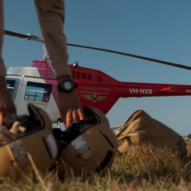 Trainee pilots picking up helmets in preparation for a training flight
